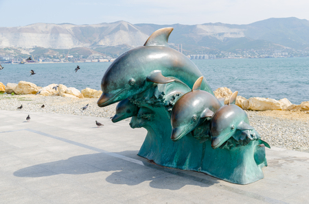 Bronze dolphins. Urban sculpture on the Shore Promenade of Novorossiysk. Novorossiysk, Krasnodar Krai, Russia - August 28, 2016.のeditorial素材
