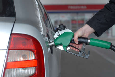 Male hand refilling the car with fuel on a filling station