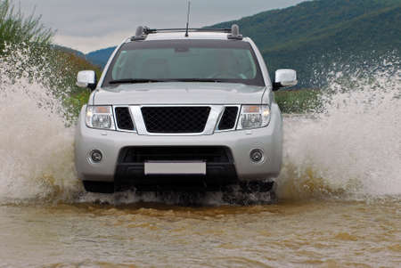 SUV crosses the river