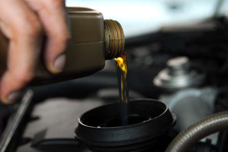 Adding Oil to a Carの写真素材