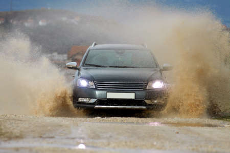 Car drives through water