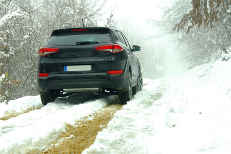 Off-road SUV in mud and snowの写真素材