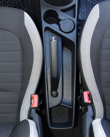 Manual brake in interior of modern car. Car parking brake.