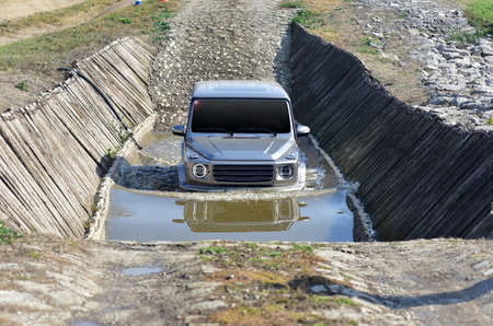 SUV crosses a water obstacle