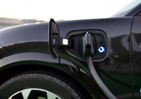 Connected charging connector to electric car. Loading energy of an electric car.