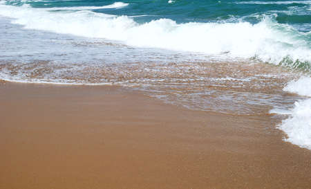 Waves running on sandy coast of Mediterranean seaの写真素材