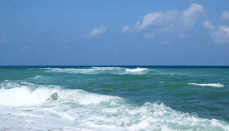 Running waves under the blue sky. Mediterranean sea.の写真素材