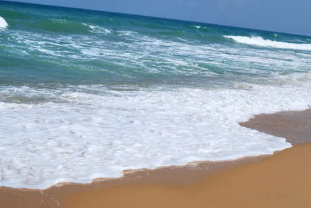 Waves running on sandy coast of Mediterranean seaの写真素材