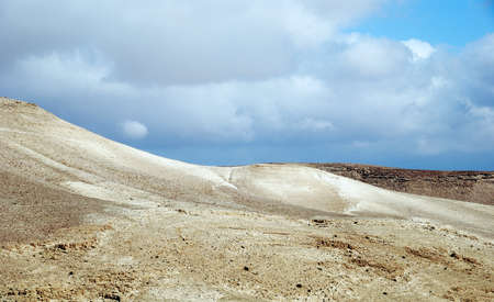 Fragment of ancient desert under dramatic sky. Desert Negev, Israel.の写真素材