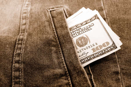 Lot of dollars in a pocket of jeans jacket.の写真素材