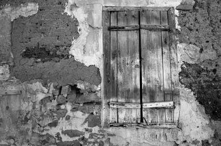 Fragment wall of old abandoned house with closed window. B&Wの写真素材