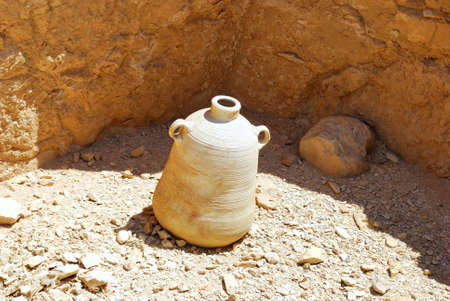 Old pitcher on a background of ancient wallの写真素材