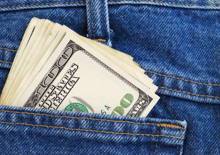 Lot of dollars in a pocket of jeans.の写真素材