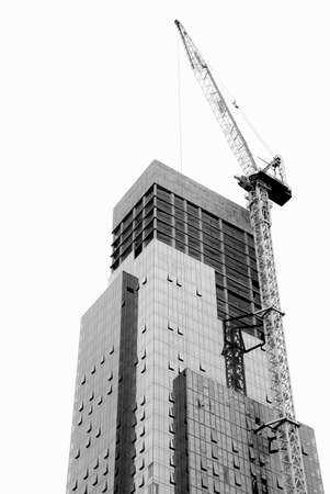 Skyscraper under construction with crane on white background. B&Wの写真素材