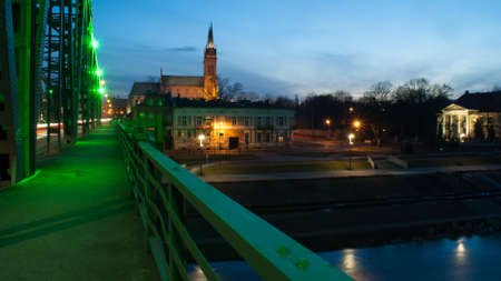 Bridge in Wloclawek gothic cathedral in the backgroundの写真素材