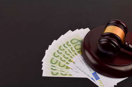 Gavel for judge lawyer with Euro banknotes on black background.の写真素材