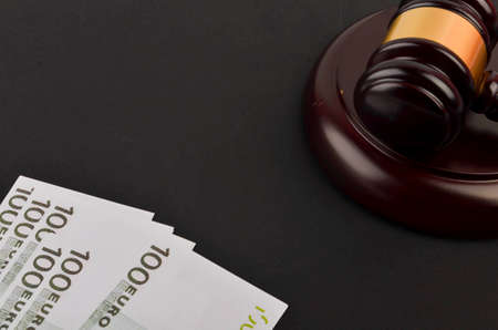 Gavel for judge lawyer with Euro banknotes on black background.の写真素材