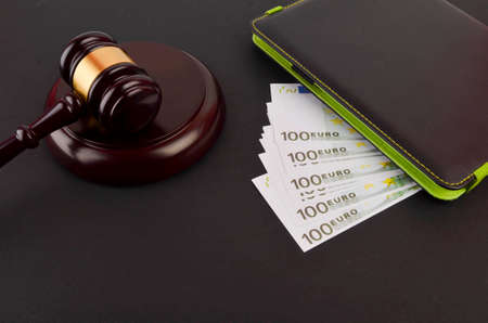 Gavel for judge lawyer with Euro banknotes on black background.の写真素材