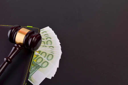 Gavel for judge lawyer with Euro banknotes on black background.の写真素材