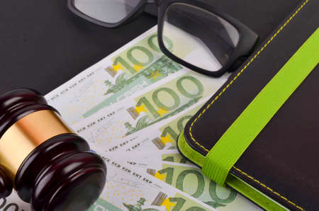 Gavel for judge lawyer with Euro banknotes on black background.の写真素材