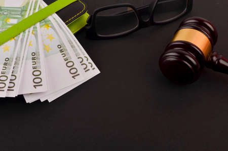 Gavel for judge lawyer with Euro banknotes on black background.の写真素材