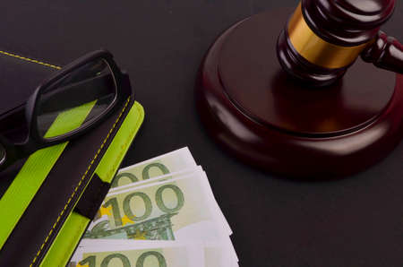 Gavel for judge lawyer with Euro banknotes on black background.の写真素材