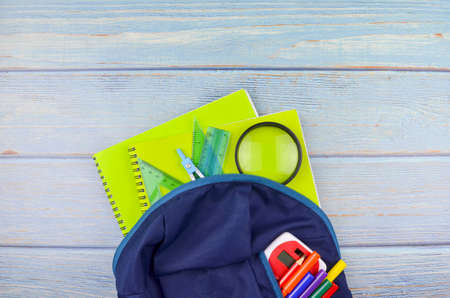 Student backpack and various school supplies, studing, education and back to school concept.