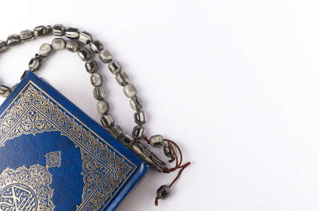 Holy Quran with arabic calligraphy meaning of Al Quran and tasbih or rosary beads