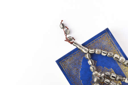 Holy Quran with arabic calligraphy meaning of Al Quran and tasbih or rosary beads