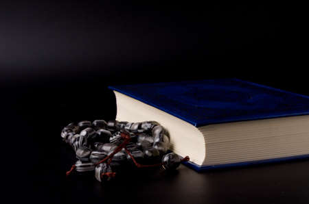 Holy Quran with arabic calligraphy meaning of Al Quran and tasbih or rosary beadsの写真素材
