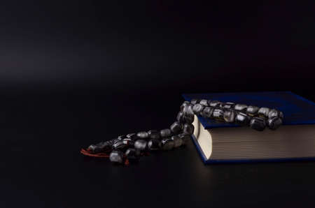 Holy Quran with arabic calligraphy meaning of Al Quran and tasbih or rosary beadsの写真素材