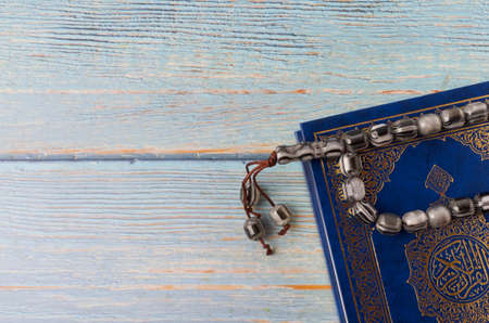 Holy Quran with arabic calligraphy meaning of Al Quran and tasbih or rosary beadsの写真素材