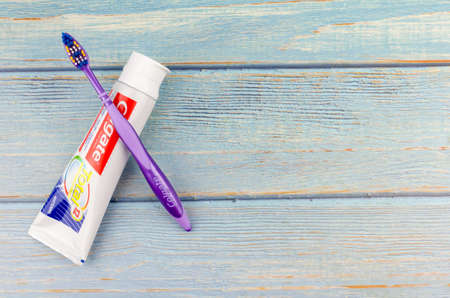 Puchong, Malaysia - July 16, 2019; Colgate toothpaste on wooden background. Brand of produced by Colgate-Palmolive.のeditorial素材