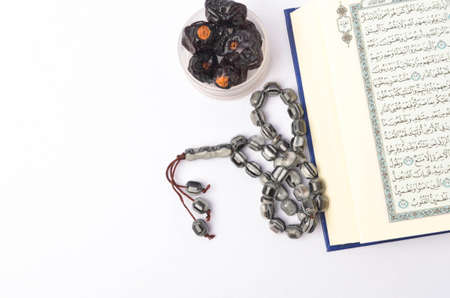 Food Ramadan dry dates or kurma with Quran and rosary. Month fasting culture Muslim and prayer for...