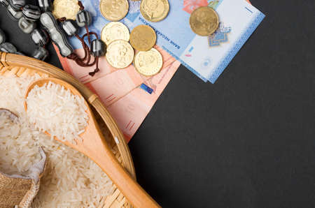 Coins, rosary, Holy Quran and rice in the sack. Zakat concept. Zakat is a form of alm-giving as a...