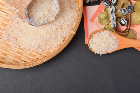 Coins, rosary, Holy Quran and rice in the sack. Zakat concept. Zakat is a form of alm-giving as a...
