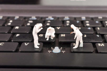 The figure of Crime Scene Investigation on keyboard. Cyber crimes concept. Selective focus.