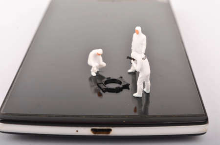 Miniature people ; Police and detective are working on smartphone, Crime Scene Investigation, cyber crimes concept. Selective focus.の写真素材