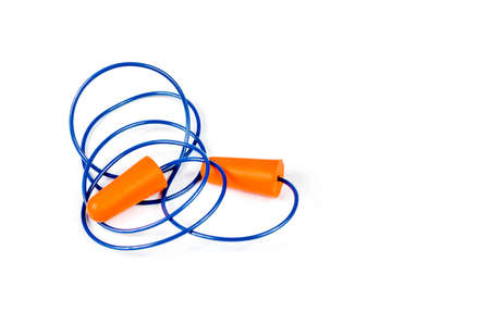 Ear plugs isolated on white background. Orange ear plugs isolated. Selective focus.