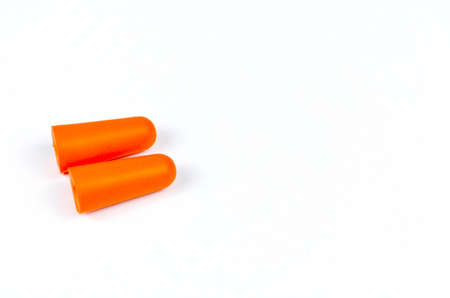 Ear plugs isolated on white background. Orange ear plugs isolated. Selective focus.の写真素材