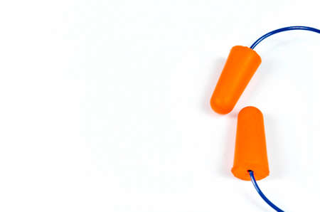 Ear plugs isolated on white background. Orange ear plugs isolated. Selective focus.