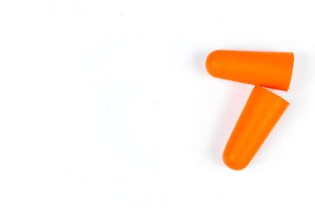 Ear plugs isolated on white background. Orange ear plugs isolated. Selective focus.の写真素材