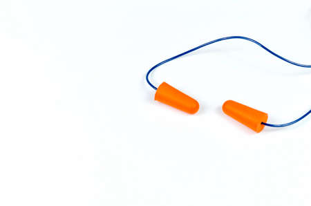 Ear plugs isolated on white background. Orange ear plugs isolated. Selective focus.の写真素材