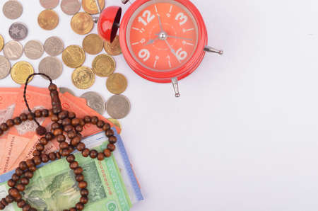 Rosary, banknotes and coins, islamic banking/finance concept. Selective focus.の写真素材