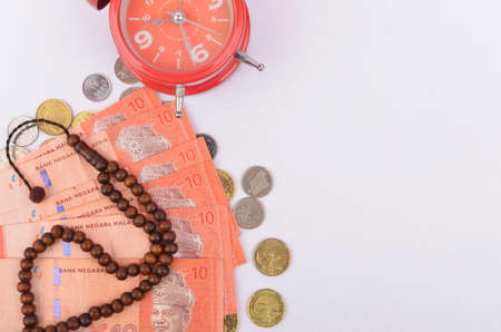 Rosary, banknotes and coins, islamic banking/finance concept. Selective focus.の写真素材