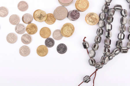 Rosary, banknotes and coins, islamic banking/finance concept. Selective focus.の写真素材