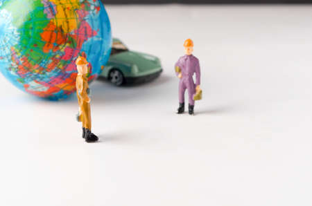 Miniature people on white background. Represent social distance of coronavirus or covid-19 issue. Social standing concept. Selective focus.の写真素材