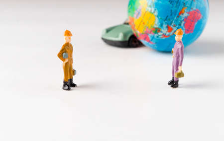 Miniature people on white background. Represent social distance of coronavirus or covid-19 issue. Social standing concept. Selective focus.の写真素材