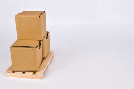 Cardboard boxes and wooden pallet on white background. Warehouse, shipping, cargo and delivery concept.の写真素材