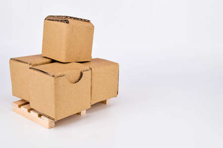 Cardboard boxes and wooden pallet on white background. Warehouse, shipping, cargo and delivery...
